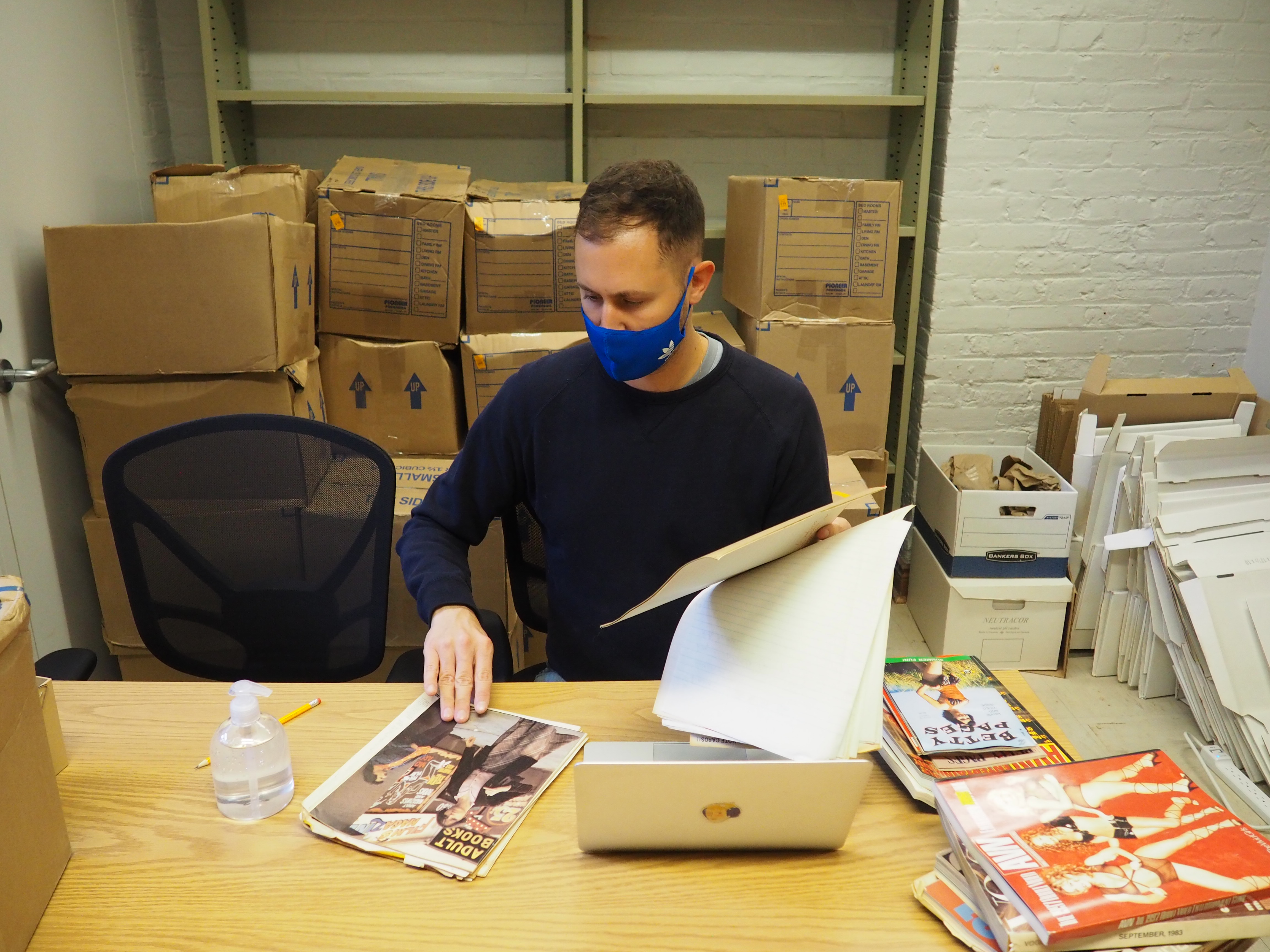 A/CA Student Researcher Daniel Laurin working with the collections