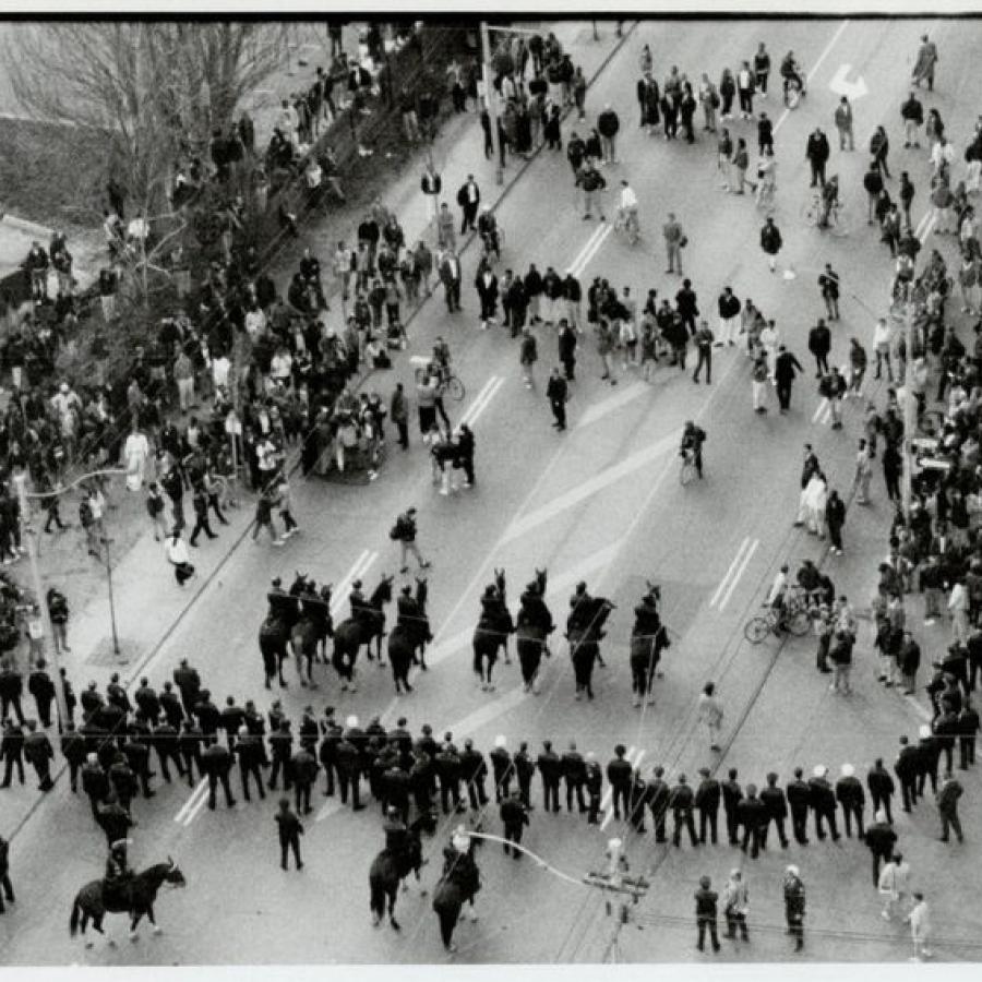 A black and white archival photo of a riot on Yonge Street in Toronto. The photo has been taken from an aerial perspective.